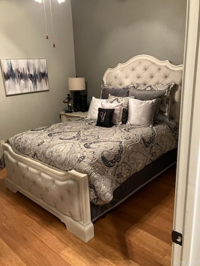 bedroom featuring wood finished floors