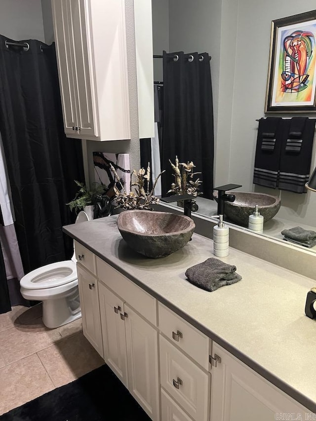 bathroom featuring toilet, vanity, and tile patterned floors