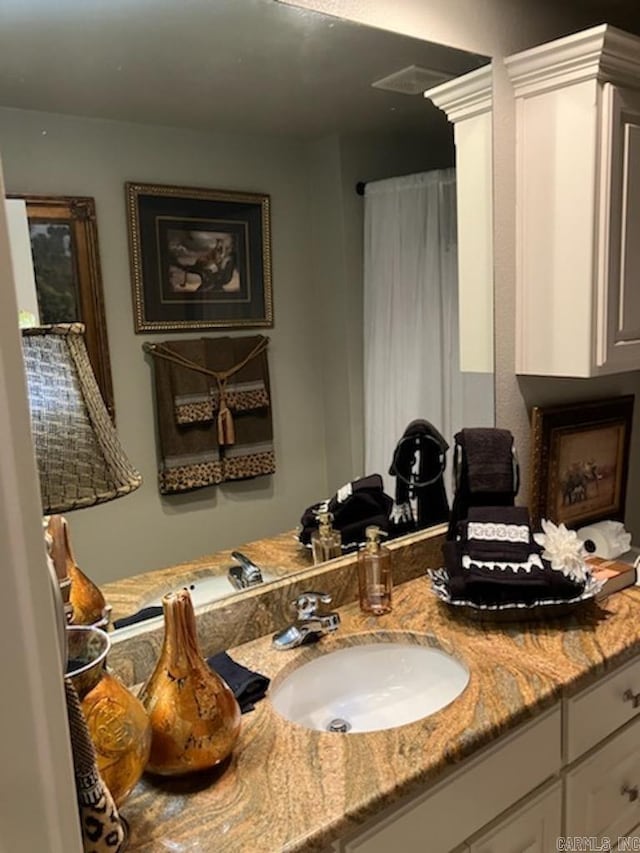 bathroom with visible vents and vanity