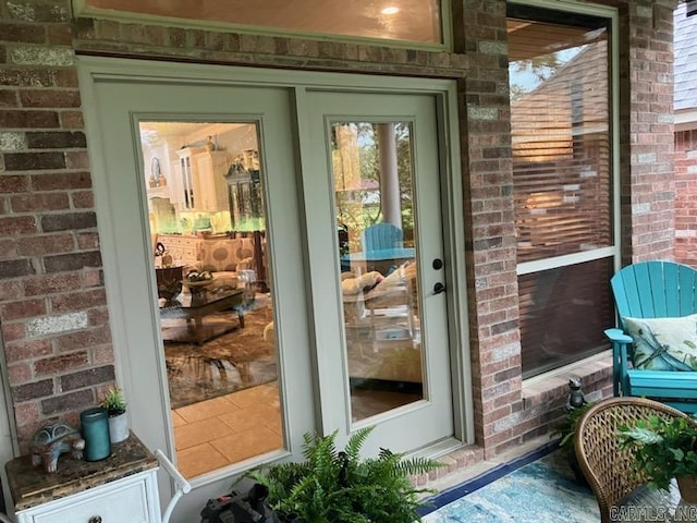 doorway to property featuring brick siding