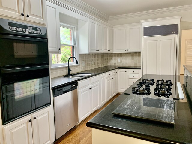 kitchen featuring white cabinets, a sink, decorative backsplash, crown molding, and black appliances