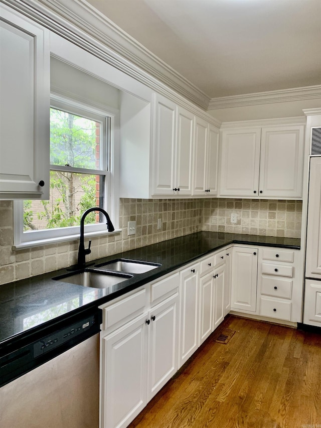 kitchen with dark wood-style floors, dark countertops, dishwasher, a sink, and white cabinetry
