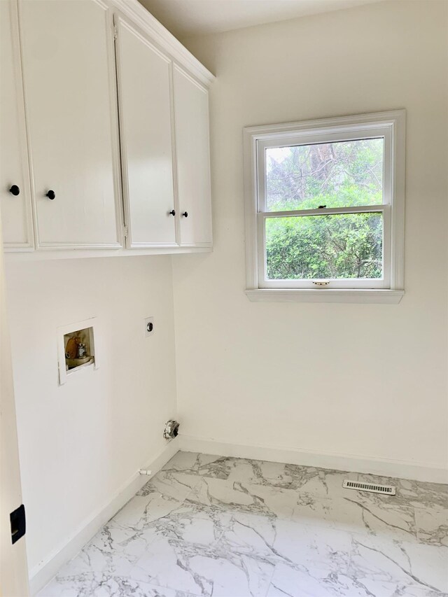 laundry room with baseboards, hookup for a washing machine, marble finish floor, cabinet space, and electric dryer hookup