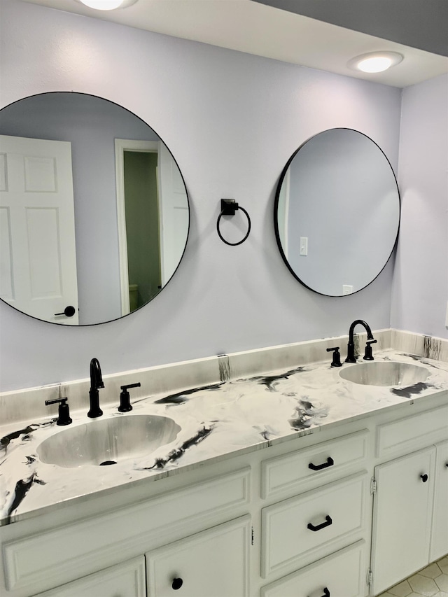 bathroom with a sink and double vanity