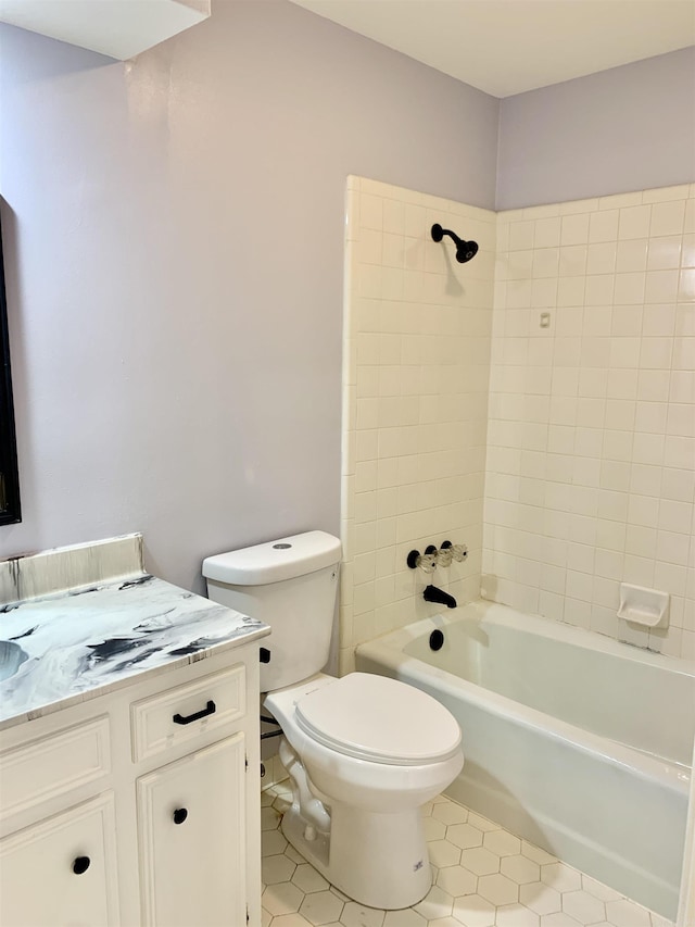 full bathroom with shower / washtub combination, vanity, tile patterned flooring, and toilet