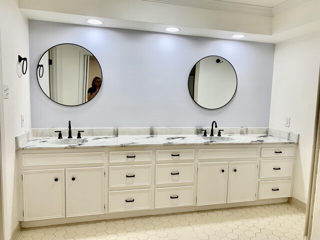 full bath featuring ornamental molding, a sink, and double vanity