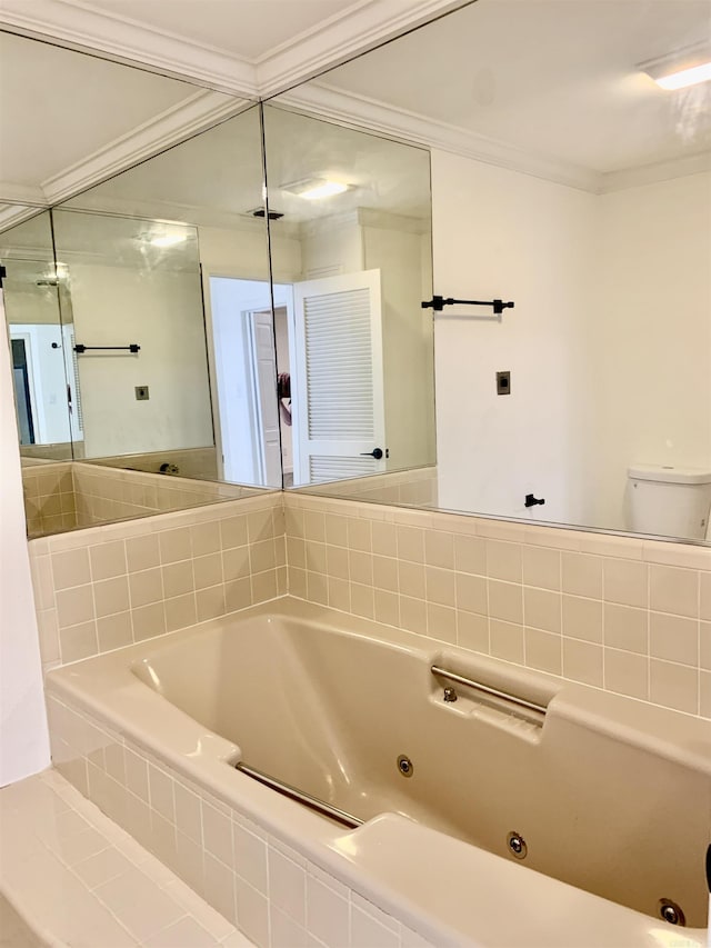 full bath featuring crown molding and a tub with jets