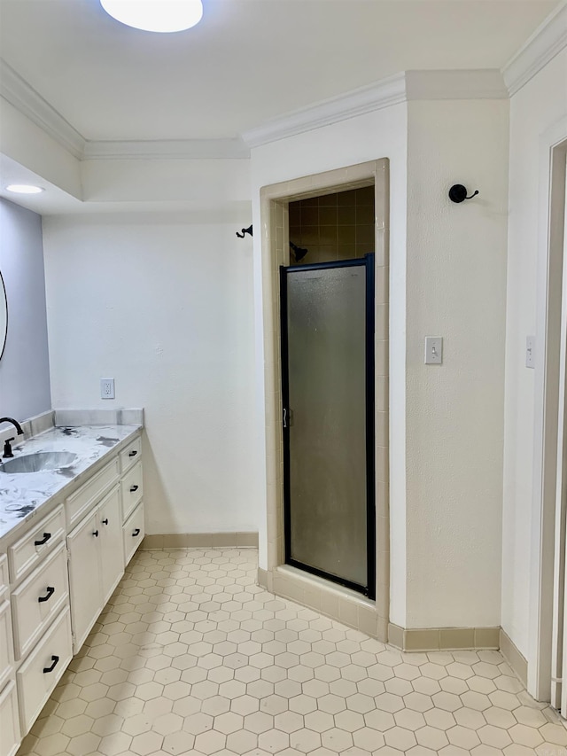 full bath with baseboards, vanity, a stall shower, and ornamental molding