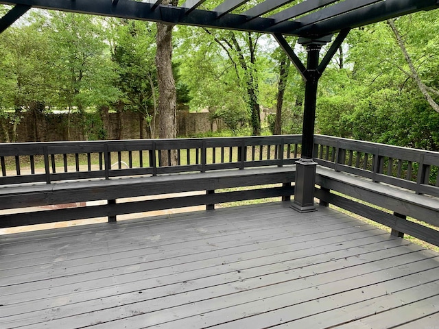 wooden terrace with fence and a pergola