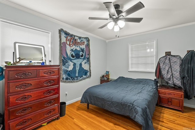 bedroom with ceiling fan, light wood-type flooring, ornamental molding, and baseboards