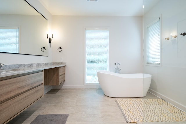 6600 Waverly Dr, Little Rock, AR 72207 - full bath featuring a freestanding bath, baseboards, vanity, and visible vents