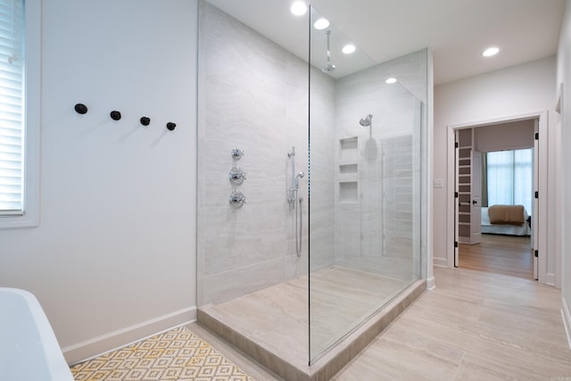 6600 Waverly Dr, Little Rock, AR 72207 - bathroom featuring a tile shower, baseboards, and recessed lighting