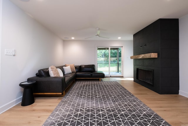 6600 Waverly Dr, Little Rock, AR 72207 - living room with light wood finished floors, a tiled fireplace, baseboards, recessed lighting, and a ceiling fan