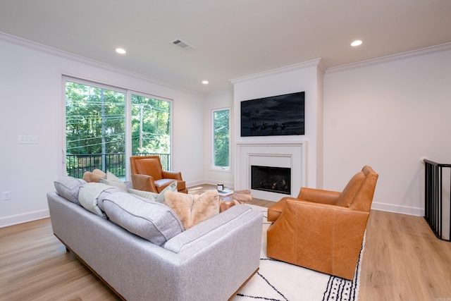6600 Waverly Dr, Little Rock, AR 72207 - living room with a fireplace with flush hearth, light wood-style flooring, baseboards, ornamental molding, and visible vents