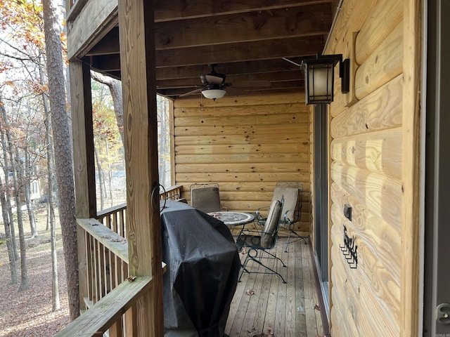 wooden terrace featuring a grill