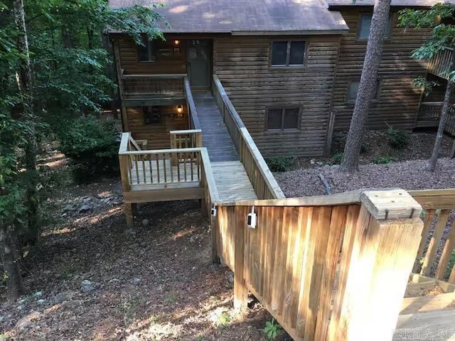back of house featuring a shingled roof