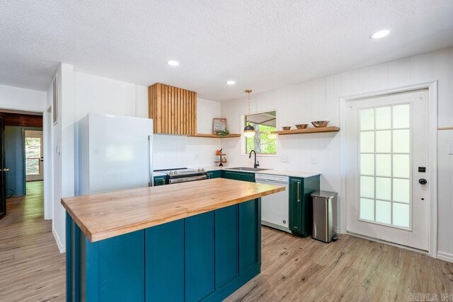 kitchen with open shelves, butcher block counters, white appliances, and a textured ceiling