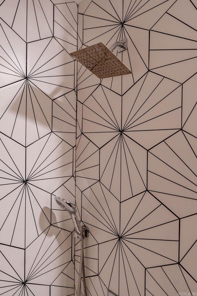 interior details featuring tiled shower