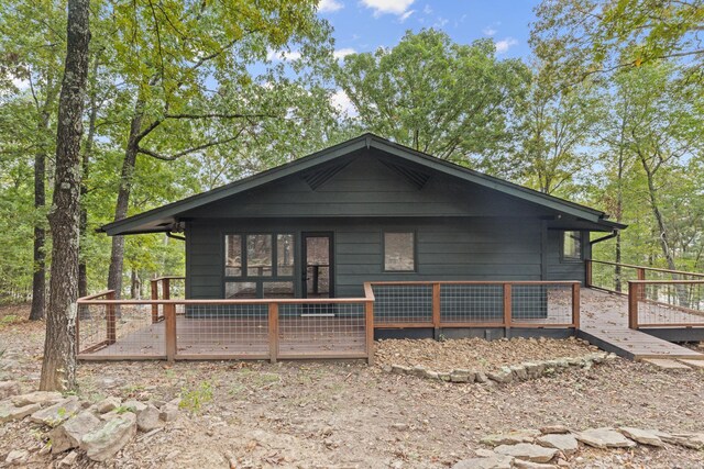 back of property with a wooden deck