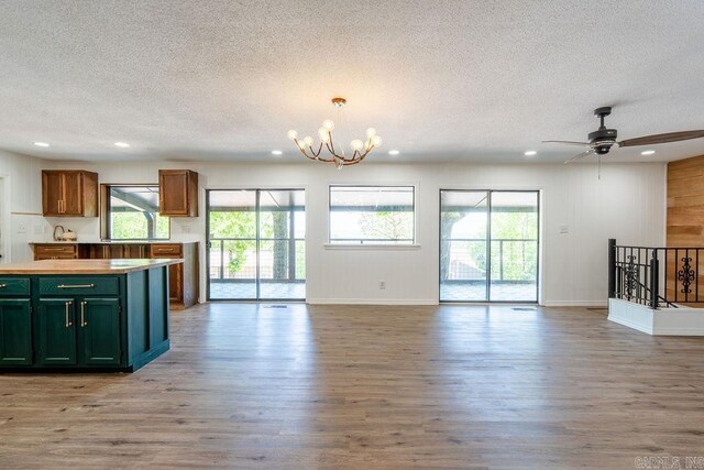 kitchen featuring light wood finished floors, plenty of natural light, a textured ceiling, and recessed lighting
