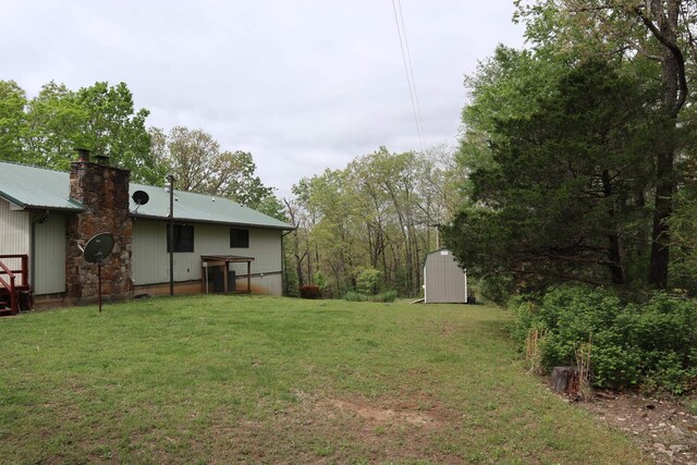 view of yard with an outdoor structure and a shed