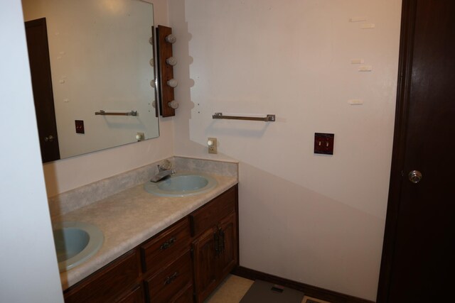 bathroom featuring a sink and double vanity