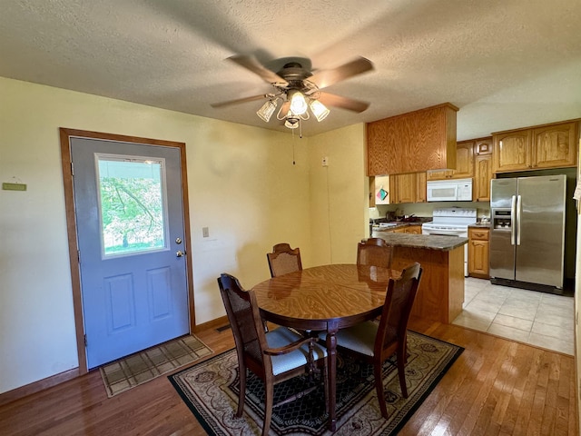 168 Knob Creek Rd, Melbourne, AR 72556 - dining area with ceiling fan, baseboards, light wood-style floors, and a textured ceiling