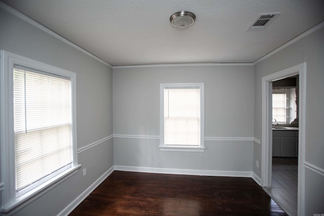 2713 S Van Buren St, Little Rock, AR 72204 - empty room featuring a sink, dark wood-style flooring, baseboards, visible vents, and ornamental molding