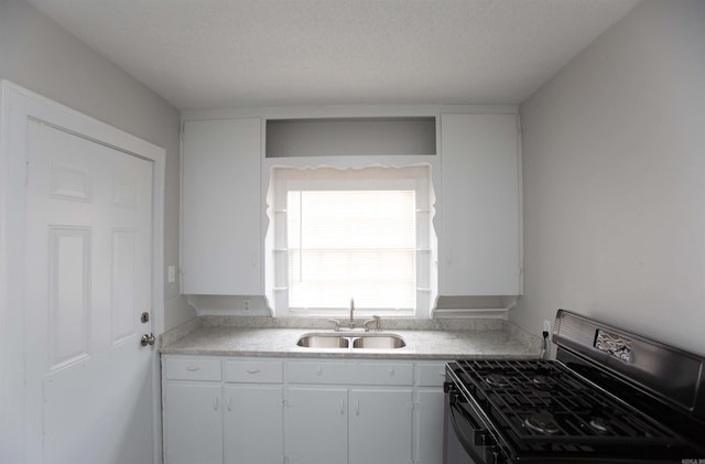 2713 S Van Buren St, Little Rock, AR 72204 - kitchen featuring white cabinets, gas stove, light countertops, and a sink