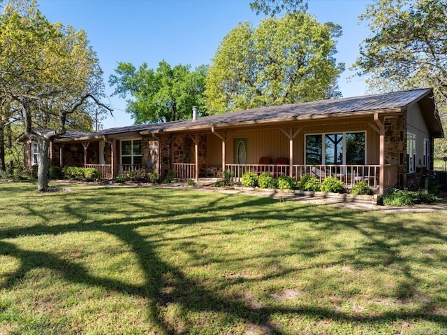 view of front of home featuring a front lawn, stone siding, and covered porch