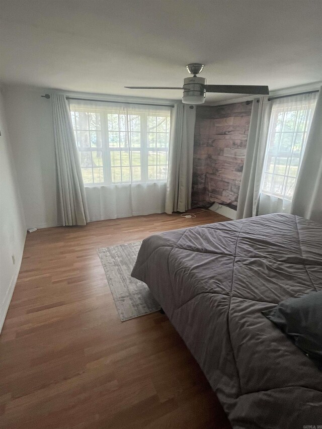 bedroom with ceiling fan and wood finished floors