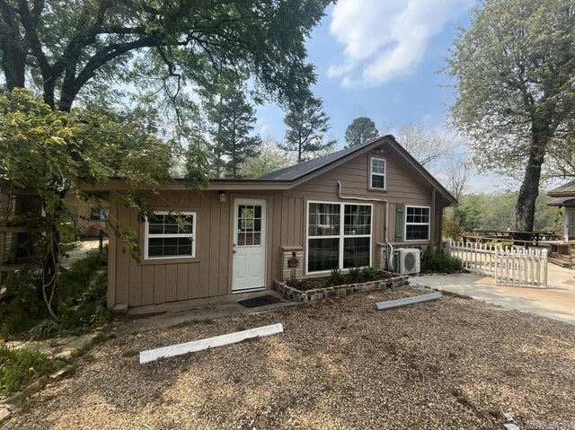 back of property with board and batten siding and ac unit