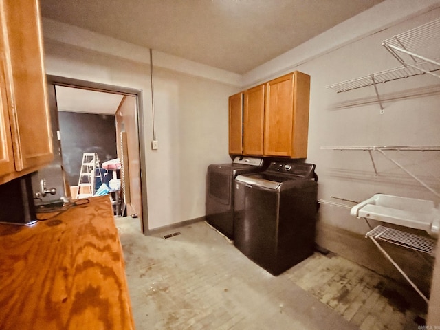 4500 Yvonne Dr, Little Rock, AR 72210 - clothes washing area with cabinet space, baseboards, and washer and dryer