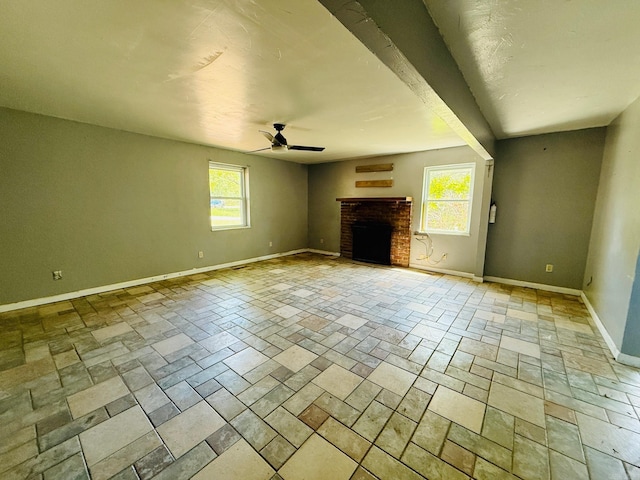 4500 Yvonne Dr, Little Rock, AR 72210 - unfurnished living room featuring stone tile flooring, plenty of natural light, baseboards, and ceiling fan
