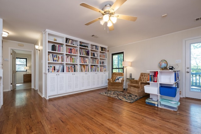 7 Sandstone Ct, Little Rock, AR 72227 - living area with plenty of natural light, wood finished floors, ceiling fan, and ornamental molding