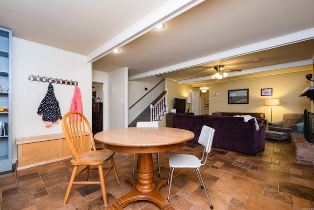 7 Sandstone Ct, Little Rock, AR 72227 - dining space with ceiling fan, stone tile flooring, and stairs