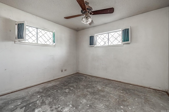 106 Nottingham Way, Prescott, AR 71857 - unfurnished room featuring unfinished concrete floors, a textured ceiling, a ceiling fan, and baseboards