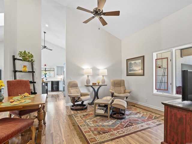 sitting room featuring high vaulted ceiling, ceiling fan, baseboards, and wood finished floors
