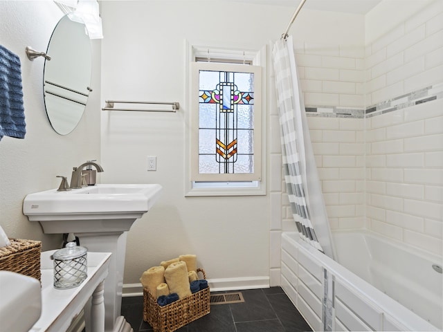 bathroom featuring baseboards, shower / tub combo with curtain, and tile patterned flooring