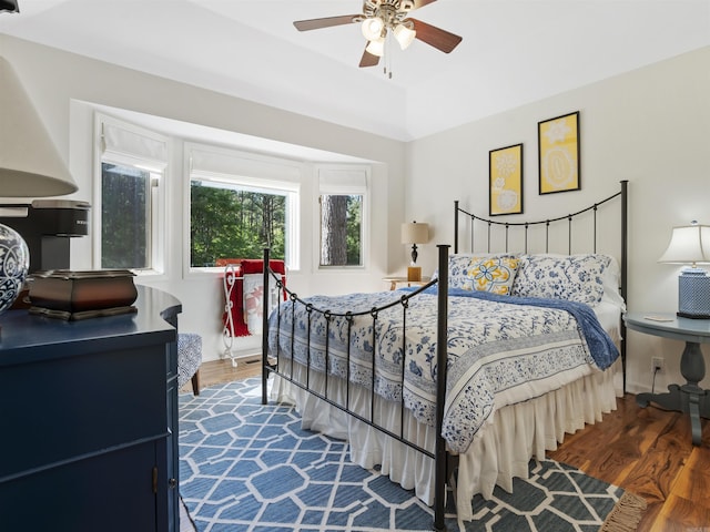 bedroom with ceiling fan and dark wood-style flooring
