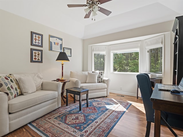 interior space featuring wood finished floors, visible vents, baseboards, and ceiling fan