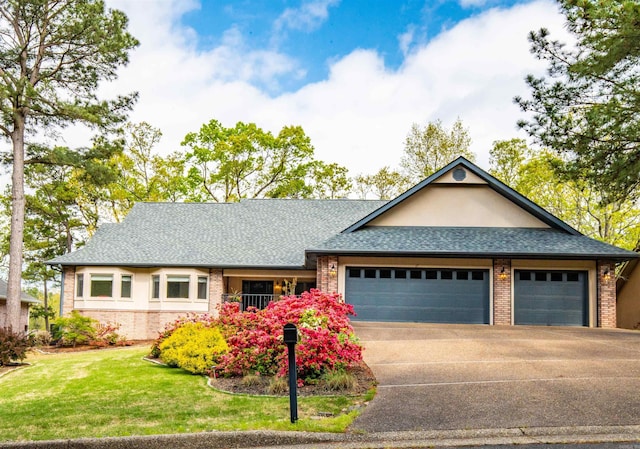 view of front of house with roof with shingles, concrete driveway, brick siding, an attached garage, and a front yard
