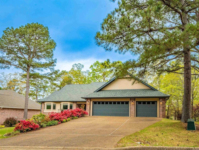view of front of property featuring brick siding, driveway, roof with shingles, and a garage