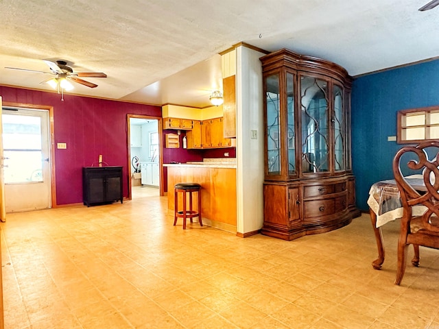40 Sutton Ln, Batesville, AR 72501 - kitchen featuring a ceiling fan, a textured ceiling, a breakfast bar area, light floors, and a peninsula