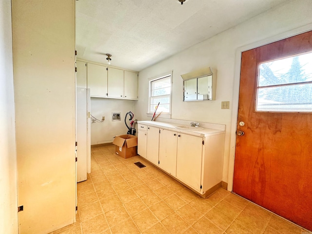 40 Sutton Ln, Batesville, AR 72501 - clothes washing area featuring visible vents, a sink, light tile patterned flooring, hookup for a washing machine, and cabinet space