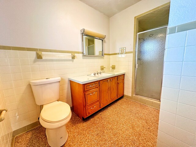 40 Sutton Ln, Batesville, AR 72501 - bathroom featuring vanity, toilet, a stall shower, and tile walls