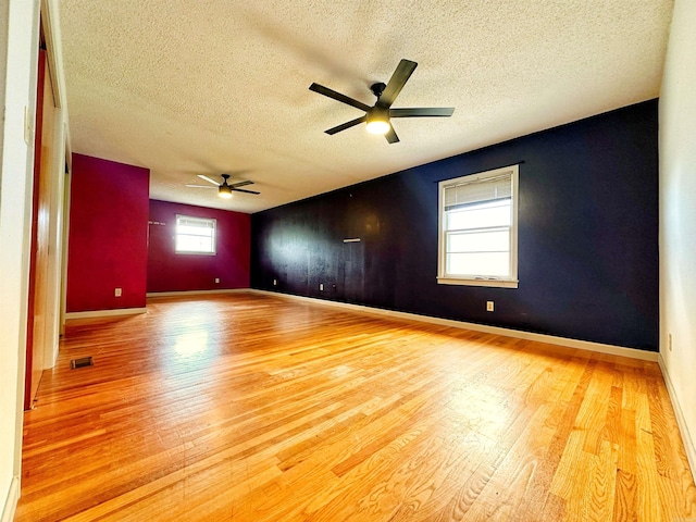 40 Sutton Ln, Batesville, AR 72501 - empty room featuring light wood finished floors, a textured ceiling, baseboards, visible vents, and a ceiling fan
