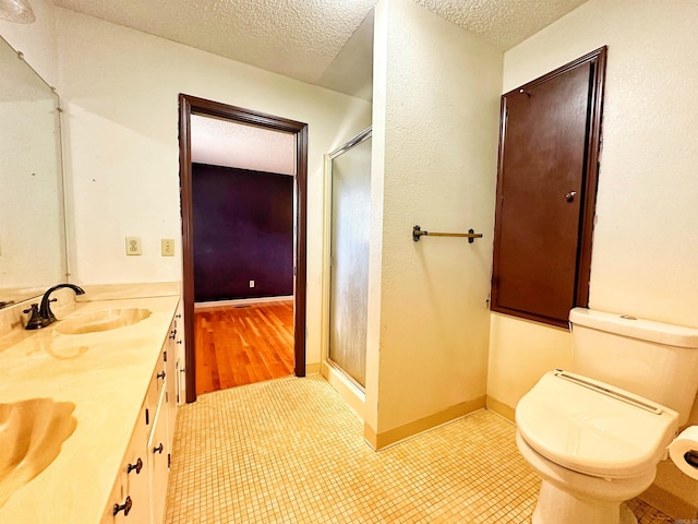 40 Sutton Ln, Batesville, AR 72501 - bathroom with toilet, a sink, a textured ceiling, and a stall shower