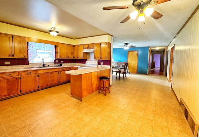 40 Sutton Ln, Batesville, AR 72501 - kitchen with brown cabinets, ceiling fan, light floors, light countertops, and white range with electric stovetop