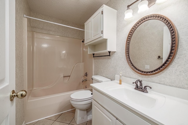 full bath with tile patterned flooring, toilet, vanity, shower / tub combination, and a textured ceiling